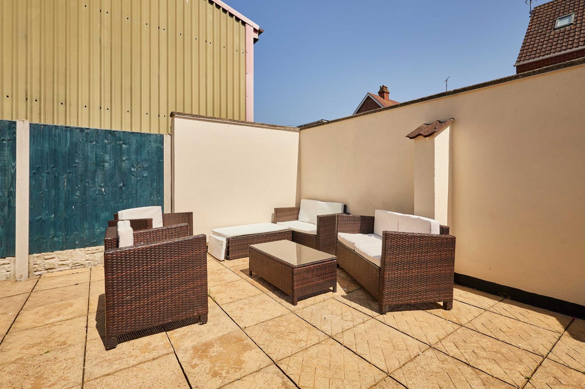 Rattan sofa set on the sun-drenched patio at Sandcastle House